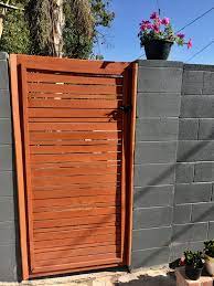 This wall is not part of a building, it's like a fence or property boundary wall, but it's made of blocks of some sort, covered up so they look like one continuous surface. Ceded Wood Door With Painted Cinder Block This Is Two Years Old Painted Cinder Block Wood Doors Tall Cabinet Storage