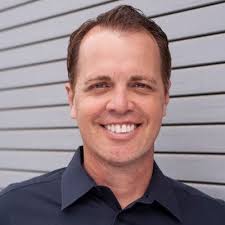 Far from his South Sudan family, a freshly minted high school graduate  celebrates with his OC village