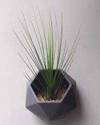 Toss a bunch of colorful faux flowers or an artificial ivy plant into this sleek planter that measures 9.00 in. 10 Modern Wall Mounted Plant Holders To Decorate Bare Walls