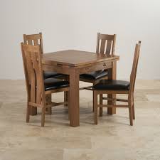 Sherwood Rustic Solid Oak Extending Dining Table 4 Arched Back Chairs With Black Leather Seat Pads Oak Dining Sets Square Dining Tables Rustic Dining Table Set