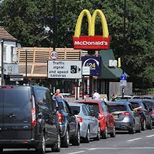 Bright yellow and red mcdonalds drive thru sign at a local mcdonalds standing in front of the mcdonalds. Busiest Mcdonald S Drive Thru Queues The 24 Restaurants To Avoid This Weekend Mirror Online