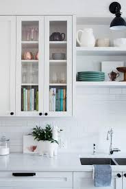 Glass Front Kitchen Cabinets Mounted To White Subway Backsplash Tiles Beside Off White Shelv Small Kitchen Decor Glass Fronted Kitchen Cabinets Kitchen Remodel