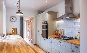 The transitional kitchen's masterpiece is the gorgeous hood with a great island! Grey Shaker Style Kitchen With Wooden Worktops Galley Kitchen Design Shaker Style Kitchens Kitchen Design Decor