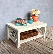 The table has a glass tabletop, a uniquely designed base, and a slanted shelf for books or magazines. Dollhouse Coffee Table Miniature Coffee Table White Coffee Table Dollhouse Room Box Diorama Handmade B Coffee Table White Coffee Table Cube Coffee Table
