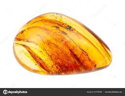 Polished Amber gem with inclusions isolated Stock Photo by ©vvoennyy  337218394