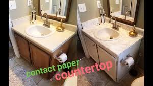 Outdated countertops can be refashioned with just about everything—from a found object mosaic to a layer of copper pennies. Diy Marble Contact Paper Over Formica Bathroom Countertop Youtube