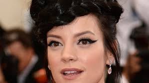 See Lily Allen dance with her top off, Spanx on