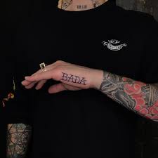 The word 'we all die at the end' tattoo along with a skull and crossbones are inked on the back of the head of lil skies. Jhonny Sacred Heart Tattoo Brooklyn