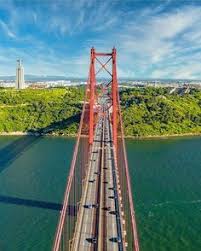 ˈpõt(ɨ) ˈvĩt i ˈsĩku ðɨ ɐˈβɾiɫ) is a suspension bridge connecting the city of lisbon, capital of portugal, to the municipality of almada on the left (south) bank of the tagus river.it was inaugurated on august 6, 1966. 9 Ponte 25 De Abril Bridge Painting Ideas Lisbon Portugal Lisbon Portugal