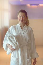 Pretty Young Woman Ready To Take A Bath Or Shower Pretty Young Woman Ready To Take A Bath Or Shower Standing In A White Towelling Bathrobe Holding A Folded To