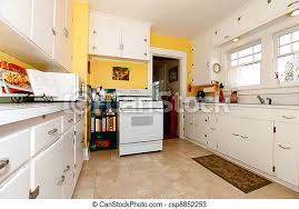 The key is to pick the spots where you want to go bold—in this case, it's the backsplash—and keep everything else simple, so the look isn't overwhelming. White And Yellow Old Simple Kitchen White Old Small Simple Kitchen Interior With Yellow Walls Canstock