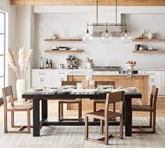 8 pottery barn chairs in dark wood with black leather seats and brass nailhead trim. Reed Dining Chair Pottery Barn