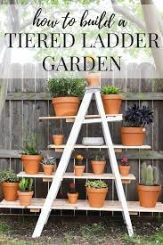It would be easy to add a solar light to this diy plant stand to illuminate the potted plant, an entryway, and increase the curb appeal of the home. Diy Tiered Plant Stand From An Old Ladder Love Renovations