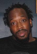 Homicide suspect charged in carjacking