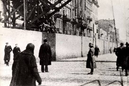 German guard in front of the Warsaw ghetto wall, February 1943