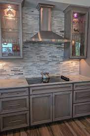 In this list, you'll find 21 best ideas of grey kitchen cabinets. Glass Doors Frame This Sleek Cooktop And Hood Featuring Our New Storm Stain Grey Cabinets Stained Kitchen Cabinets Gray Stained Cabinets