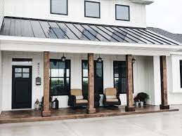 Modern white farmhouse exterior like the pop out window and metal roof accent. White With Black Modern Farmhouse Porch Metal Roof Modern Farmhouse Porch Modern Farmhouse Exterior Barn House Plans