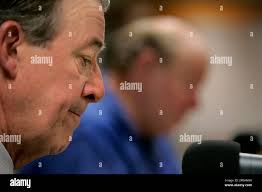 Dennis Haslam, president of the Utah Jazz, listens to owner Larry Miller,  rear, talk about during a news conference Wednesday, July 18, 2007, in Salt  Lake City. Haslam, president of the Utah