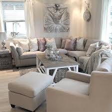 Elegant pink and gray living room features pink accent chairs placed on a silver and gray rug at an extra large gray coffee table positioned under a ceiling accented with rustic wood beams. Light Grey Living Room Decor Ideas Novocom Top