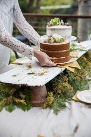 Resting on a flared trestle base, our country&#45;rustic wooden dining table features a smooth surface inspired by slab tables, with dark distressing that creates an organic, aged feel. Flower Pots Under Rustic Board Wedding Desserts Wedding Food Dessert Table