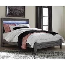 These exquisite pieces feature a smokey gray finish over replicated oak grain, contemporary gunmetal finished hardware and slide roller glides for smooth, functional drawers. Signature Design By Ashley Baystorm Queen Panel Bed With Dimming Led Light Royal Furniture Platform Beds Low Profile Beds