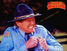 Deputy Enos Strate observing Boss Hogg in the Grey Ghost Jr brushing up