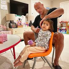 Dwayne Johnson is showing off his "exceptional hair skills" as he brushes  his daughter Tiana's tangles. 💕 "I may be bald but I know a thing or two  about hair. Mainly because