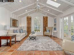 Contemporary Living Room With Terracotta Tile Floors Skylight Arched Window Beach Apartment Decor Terra Cotta Tile Living Room Living Room Tiles