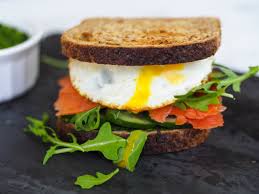 An indulgent breakfast sandwich made with a toasted, flaky croissant, smoked salmon, eggs, chives, avocados and havarti cheese. Smoked Salmon Avocado And Pesto Breakfast Sandwich Registered Dietitian Columbia Sc Rachael Hartley Nutrition