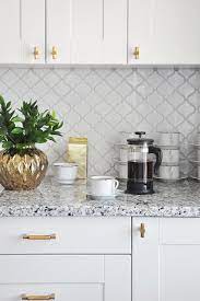The square footage determines how much tile is necessary for tiling a backsplash in a kitchen. White Glazed Porcelain Arabesque Backsplash Tile Backsplash Com