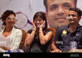 London Olympics bronze medal winner for boxing, Mary Kom, center, gestures,  as shooting silver medalist Vijay Kumar, right, and Bollywood actress  Deepika Padukone, left, look on, during a presentation in Mumbai, India,