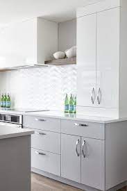 High gloss seems as popular now as it was when it was last trending in the 1970s. A Glossy White Hood Positioned Between Wood Shelves Is Flanked By Glossy Flat Front Whit Contemporary Kitchen Cabinets White Modern Kitchen Kitchen Room Design