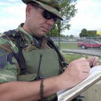 MASTER Sergeant (MSGT) Rob Alger, USAF, 138th Security Police Squadron,  Oklahoma Air National Guard, checks drivers licenses and ID cards of  personnel coming onto the base. This security precaution is in response to  the terrorist attacks