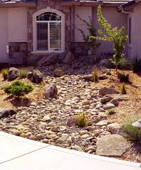 Dry Stream Bed Perfect For Using Under Roof Downspouts To Retain Runoff Dry Riverbed Landscaping Outdoor Gardens Evergreen Landscape