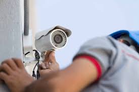 A professional technician installing a security camera.