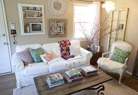 A rope hanging sofa accented with white cushions and gray pillows hangs in a portico over red and gray brick pavers. White Sofa Colorful Cushions Best Small Living Room Decor Design Ideas Homepimp