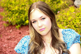 I took this photo at my senior homecoming but the lights were so low. Can  anyone take the little green and red lights off of our faces, maybe  brighten the photo up,