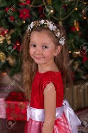 And you can buy this handmade minnie mouse costume with crochet, earflap hat (black beanie with red polka dot bow), diaper cover, skirt, long tail. Little Beautiful Girl In Red Dress At The Christmas Tree Portrait Of Cute Baby In The New Year Decorations Stock Photo Picture And Royalty Free Image Image 67410526