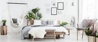 Bedroom benches king size bed. White Fur On Bench In Spacious Natural Bedroom Interior With Hammock King Size Bed Plants And Posters Stock Photo Picture And Royalty Free Image Image 93386547
