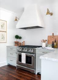 So keep an eye peeled for coupons and online sales. Light Green Kitchen Cabinets With White Range Hood Transitional Kitchen