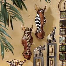 Fill a mantel with picture frames and fill your home with memories. Heyvan Hand Carved Masks From Seventh Avenue African Safari Decor Palm Frond Art Safari Home Decor