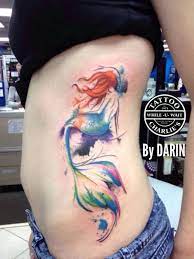 The head of the mermaid is a skull, but her body remains in human form and has additional fins on her colorful tail. Beautiful Mermaid Tattoo Ideas For Creative Juice