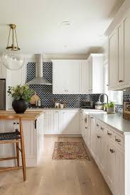 The backsplash should enhance that look. Black Backsplash Tiles With White Cabinets Transitional Kitchen