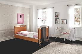 Many patients, of all ages, wear high top sneakers in connection with the use of a footboard; Allura Ii Care Beds To Meet Every Challenge Burmeier