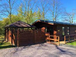 Nestled in an sssi (special site of scientific interest) and aonb (area of outstanding natural beauty), the cabins, designed in. Log Cabins With Hot Tubs In North Wales Llannerch Holiday Park Log Cabins
