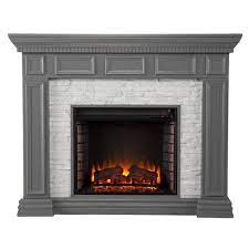 It is a white electric fireplace with faux stone in a traditional style with a coastal touch. Brothye Faux Stone Electric Fireplace Gray Aiden Lane Target