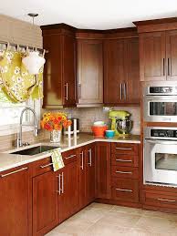 Mainstream Beauty Rich Cherry Cabinets With Oversize Hardware A Glass Tile Backsplash And Quartz Cherry Cabinets Kitchen Kitchen Renovation Kitchen Remodel