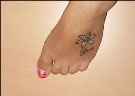 Small And Simple Lily Tattoo On Foot For Girls Lily Flower Tattoos Lily Tattoo Small Lily Tattoo