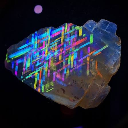 At first glance, this looks like a piece of futuristic technology trapped  inside crystal—but it's actually a real gemstone called Rainbow Lattice  Sunstone. Found only in a small, remote area of Australia's