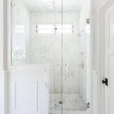 Here, light gray colorizes the walls and dark grey flooring complements it very well. Carrera Marble Shower Tiles Design Ideas